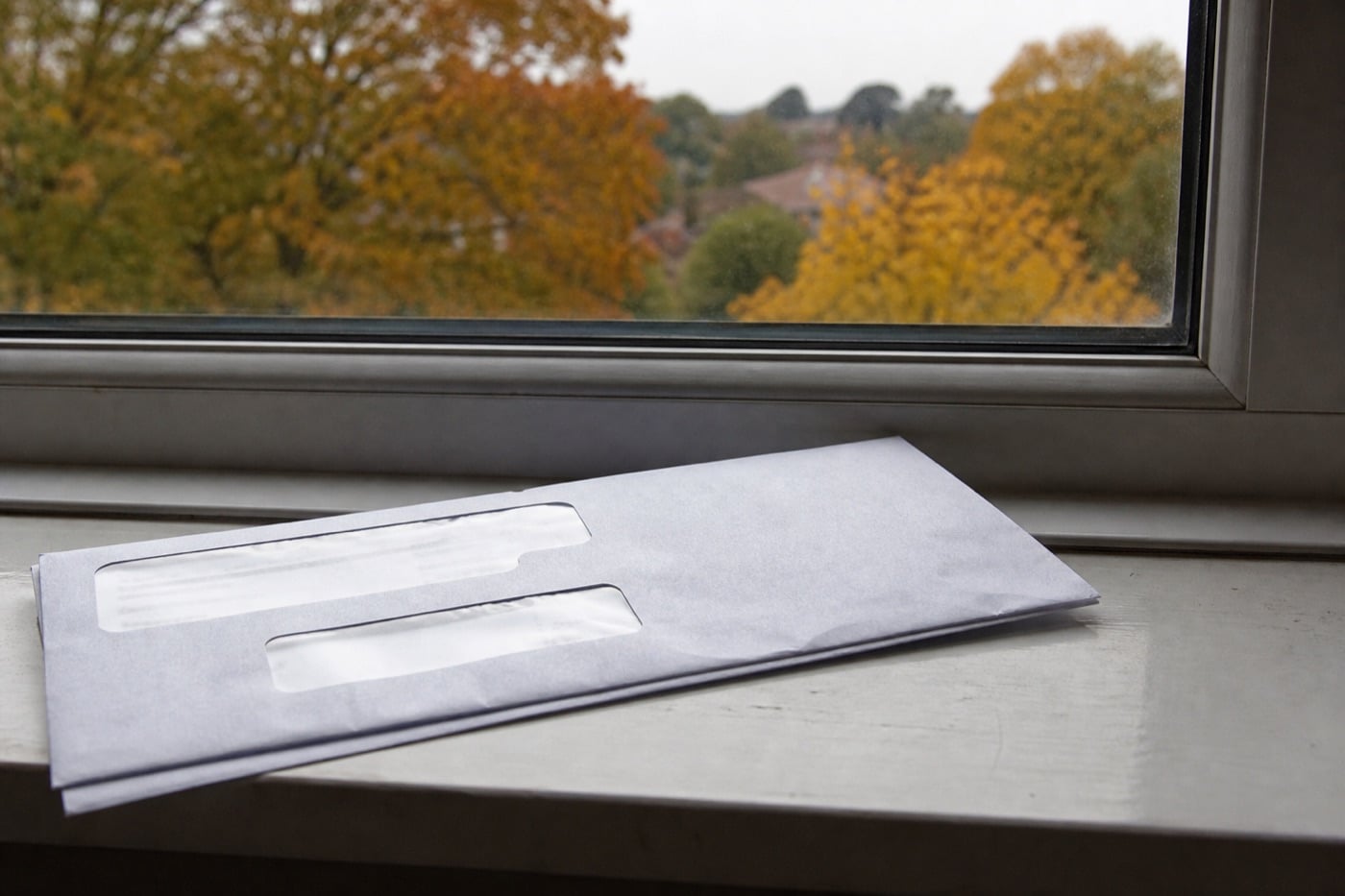 A UK pension statement envelope on a windowsill